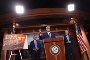 Senator Bill Cassidy and others speak at a podium about their latest proposal to lower the cost of higher education.